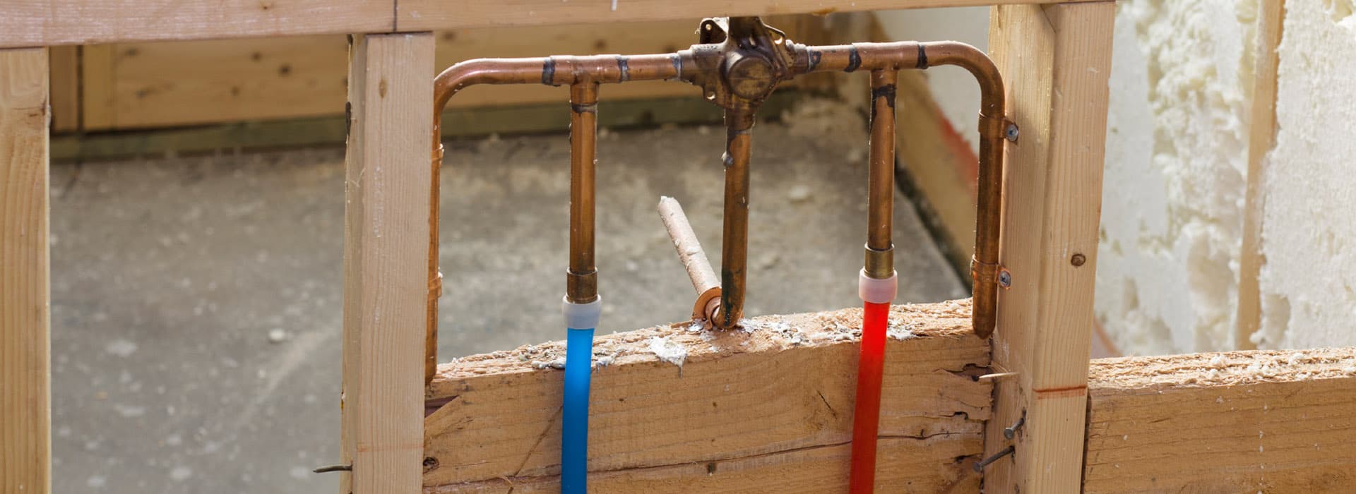 Copper plumbing with red and blue PEX water lines